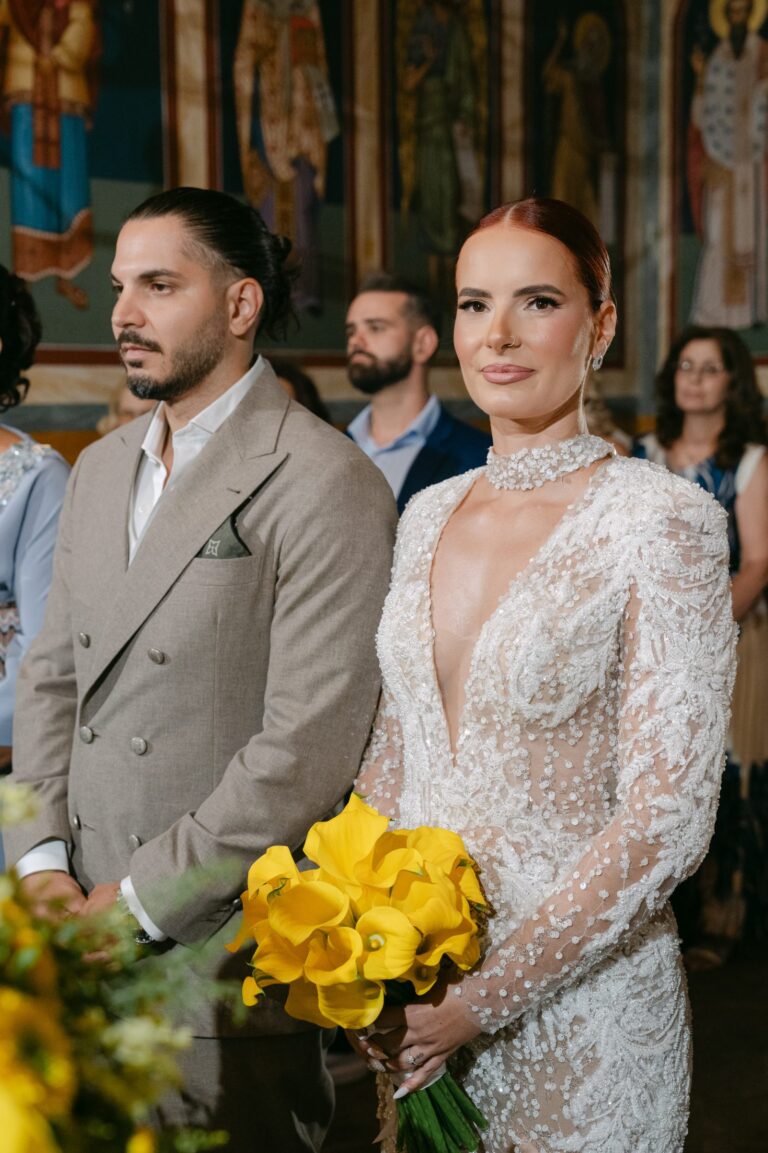 Andreas & Ioanna, wedding in Patras: the couple in church, with yellow calla lilies